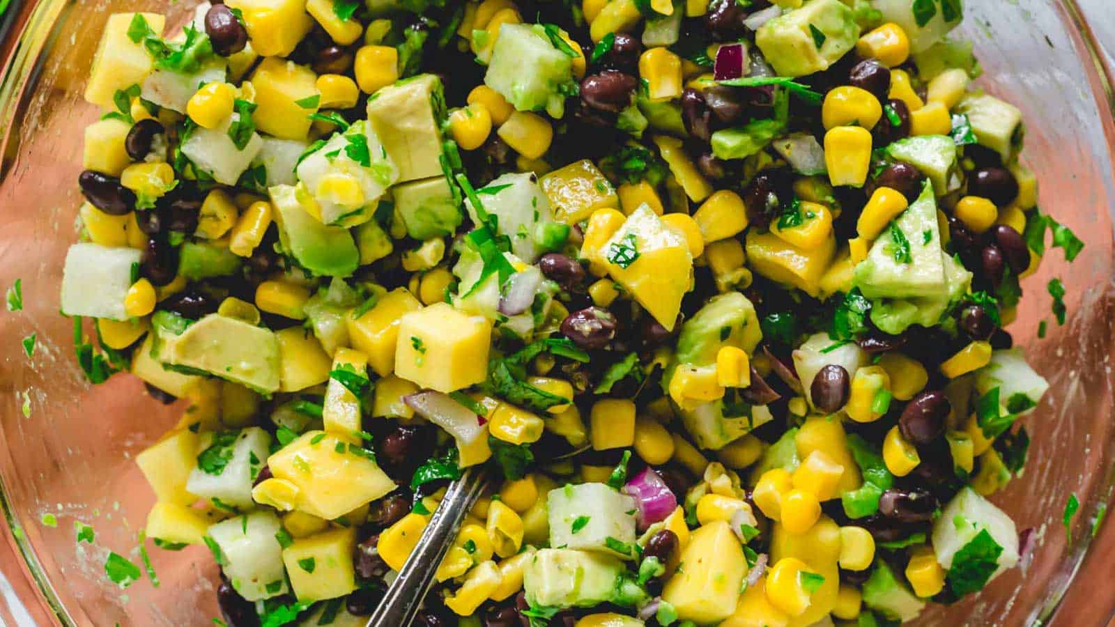 Mango black bean salad in a glass bowl.