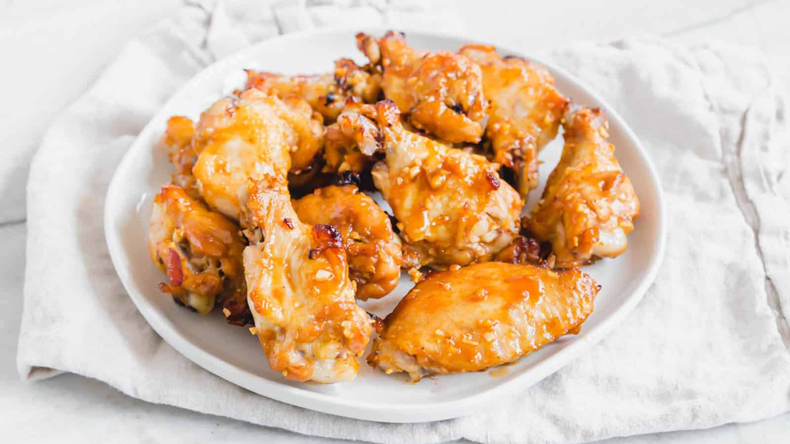 Crispy oven baked marinated chicken wings on a plate.