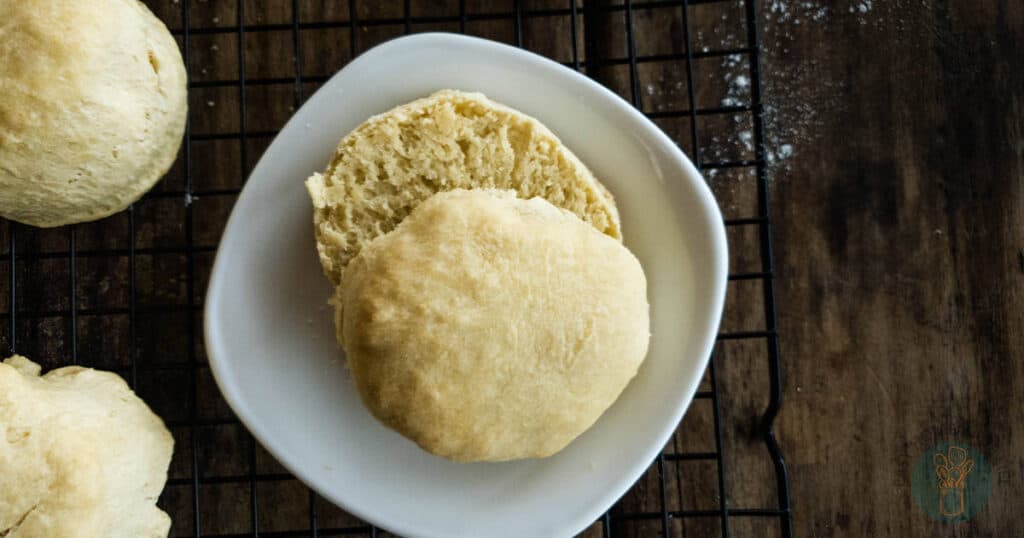 Two pieces of bread on a plate on a wooden rack.