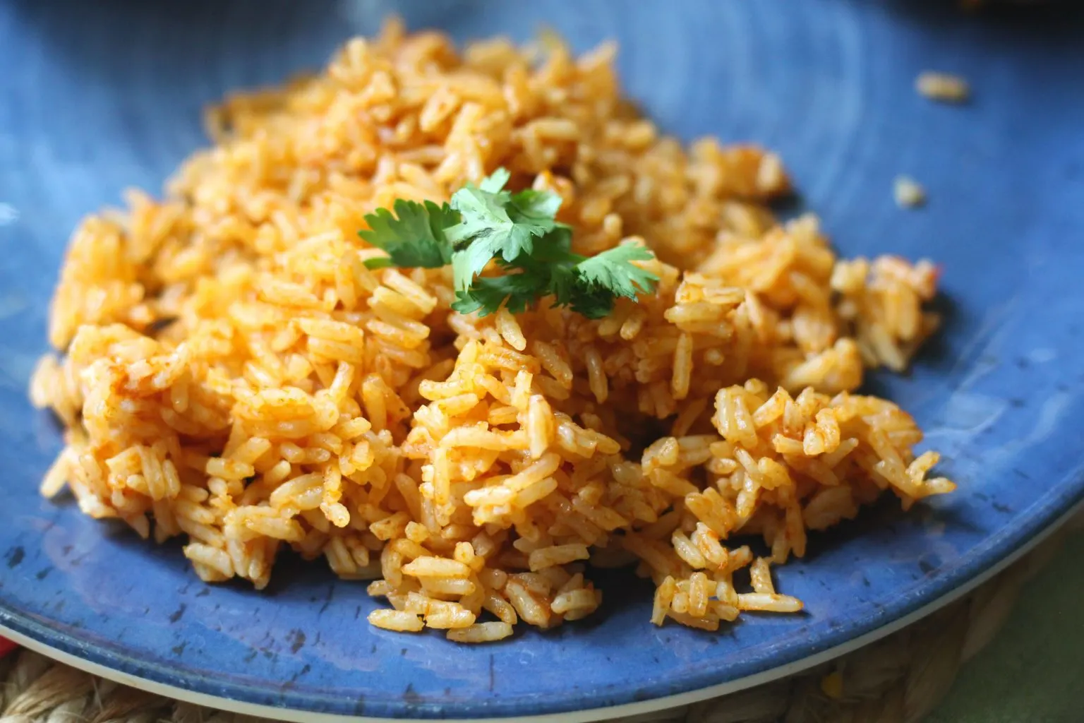 Mexican rice on a blue plate.