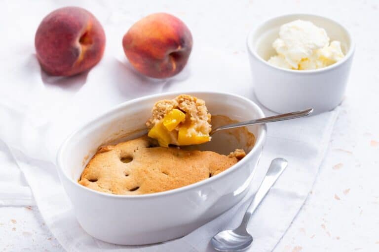 Peach cobbler with ice cream and peaches.