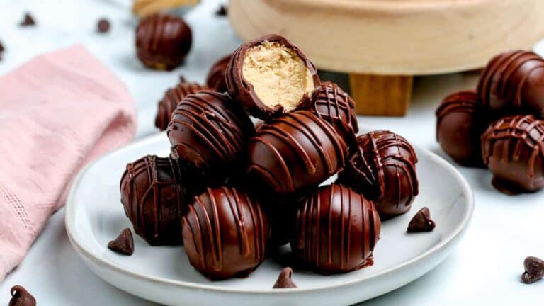 Peanut butter balls on a white plate.