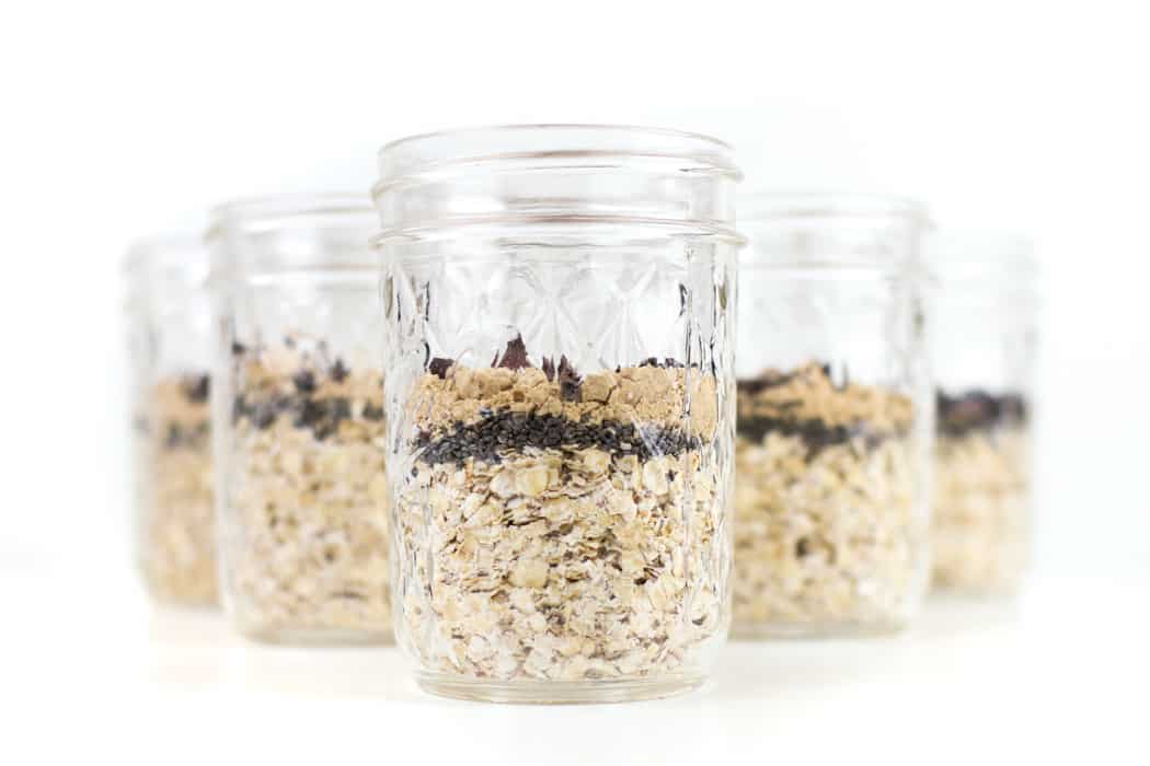         Easy breakfast: Oats in mason jars on a white background.