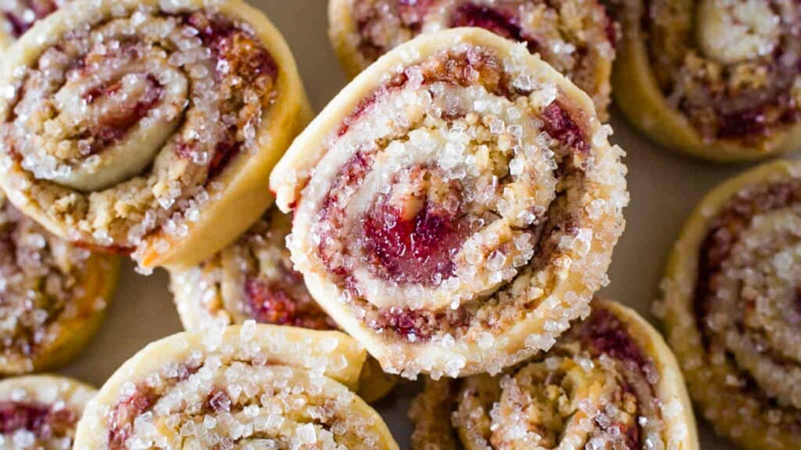 Top view of raspberry pinwheel cookies topped with sparkling sugar.