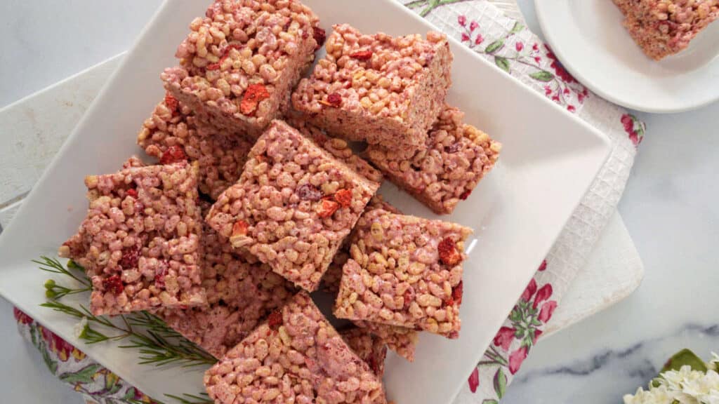 Strawberry rice krispie treats on a white plate.
