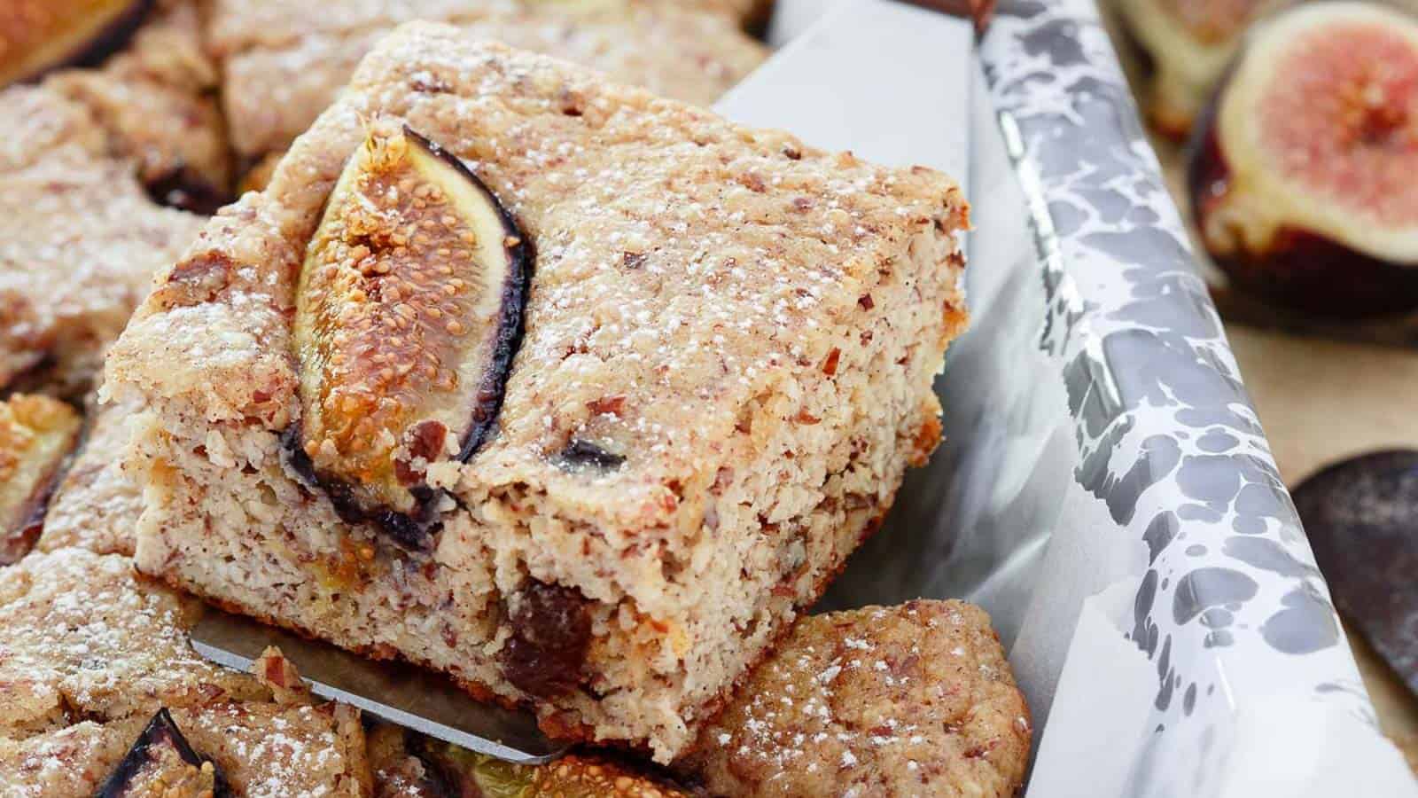 Slice of ricotta almond fig cake on a metal spatula.