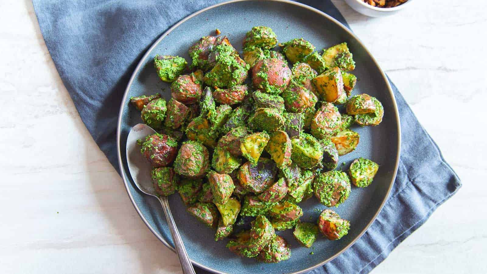 Pesto potatoes on a blue plate.