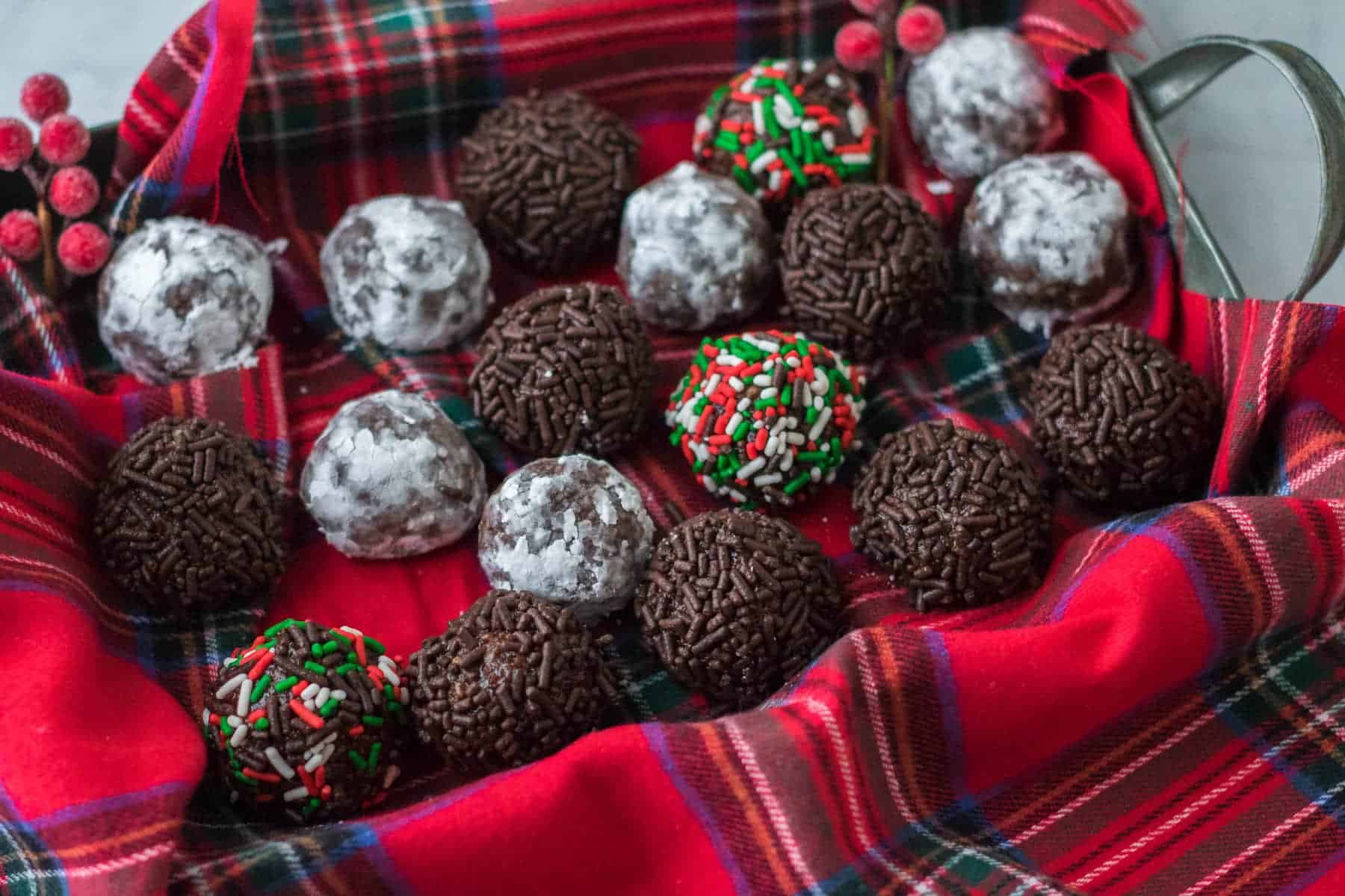 Rum balls with chocolate sprinkles in a tray.