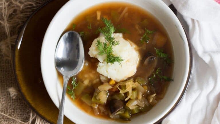 A bowl of soup with a spoon in it.