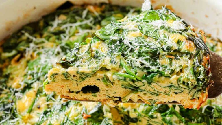 A slice of quiche with spinach and parmesan.