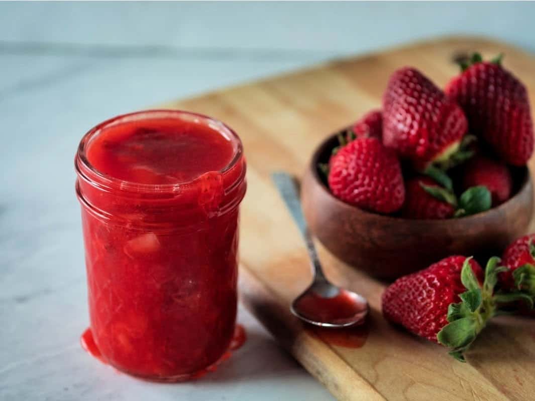 Mason jar with strawberry sauce.