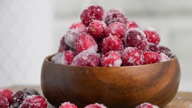 Cranberries in a bowl with sugar on top.