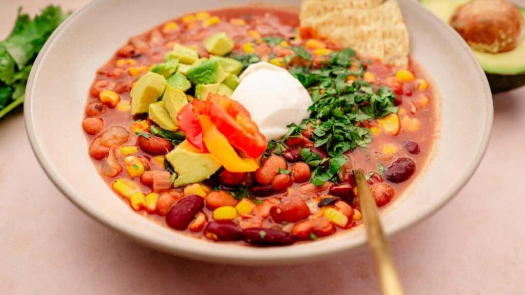 A five-star bowl of chili with sour cream and avocado.