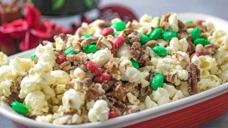 Christmas popcorn in a red dish with green and red sprinkles.