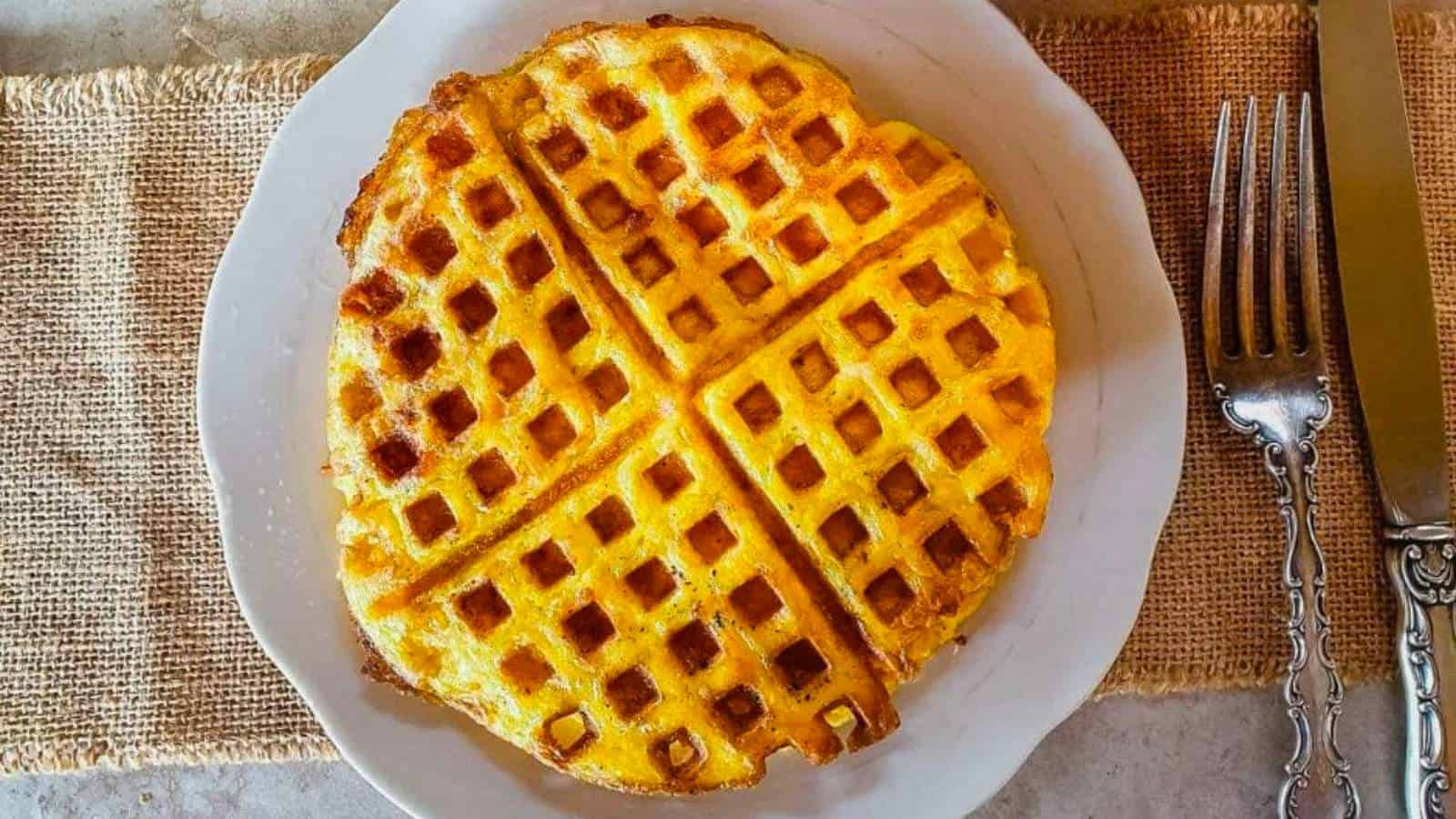 Waffles on a plate with a fork and knife.