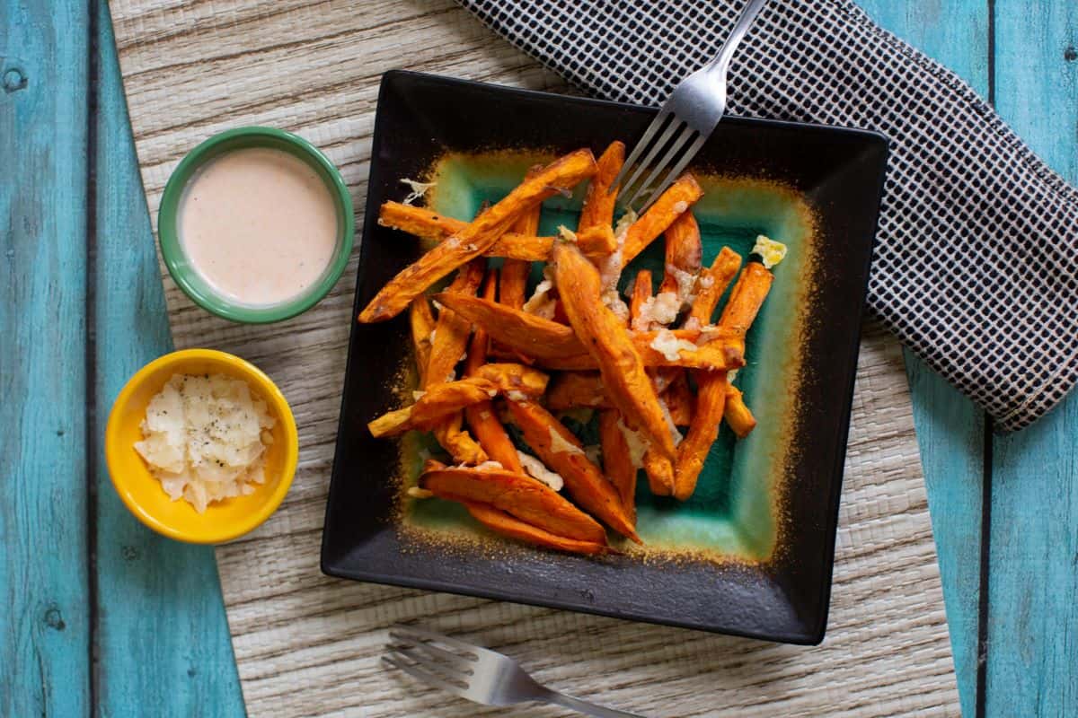 Sweet potato fries on a plate with a fork.