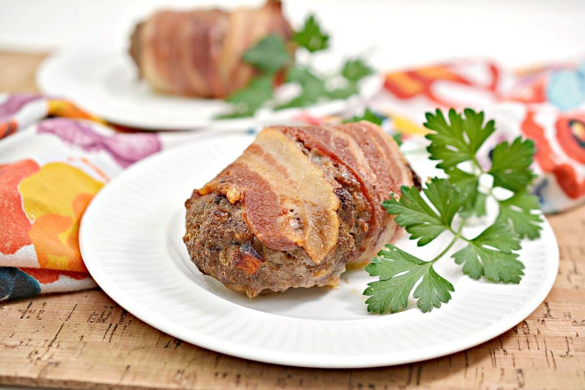 Bacon wrapped meatloaf on a plate.