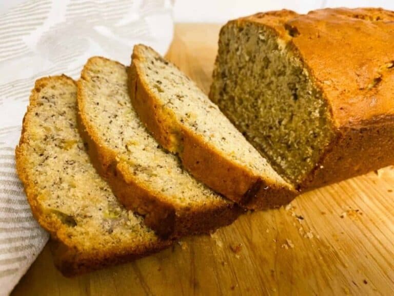 Sliced banana bread on a cutting board.