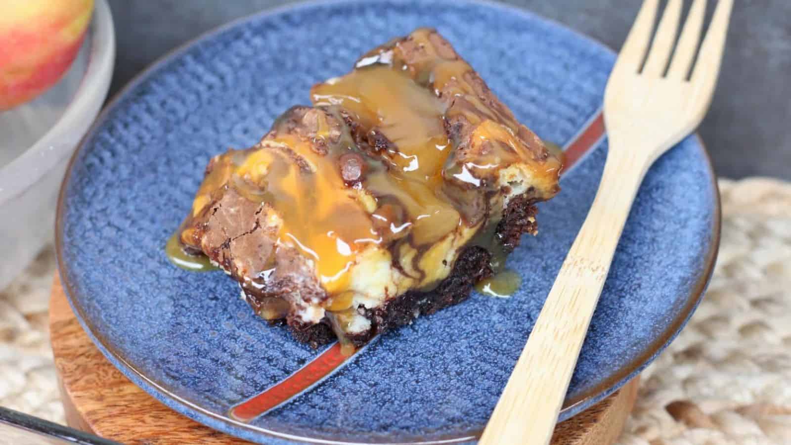 A piece of cake on a blue plate with a fork.