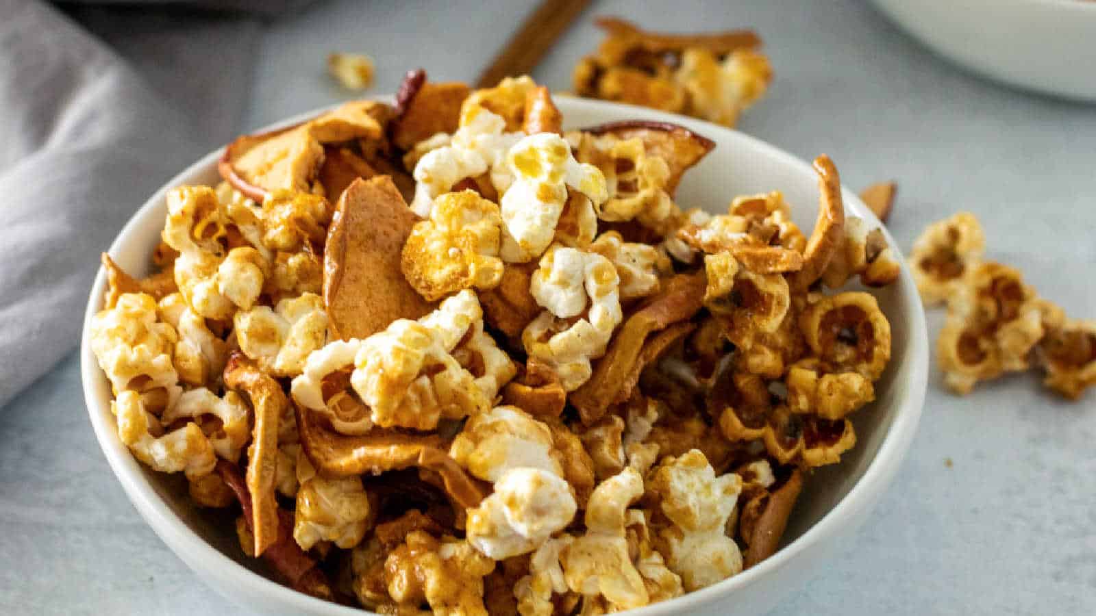 A white bowl with caramel apple popcorn.