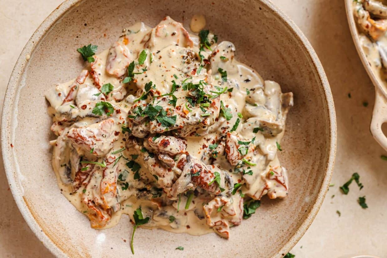 Chicken with creamy mushroom sauce in a pan.