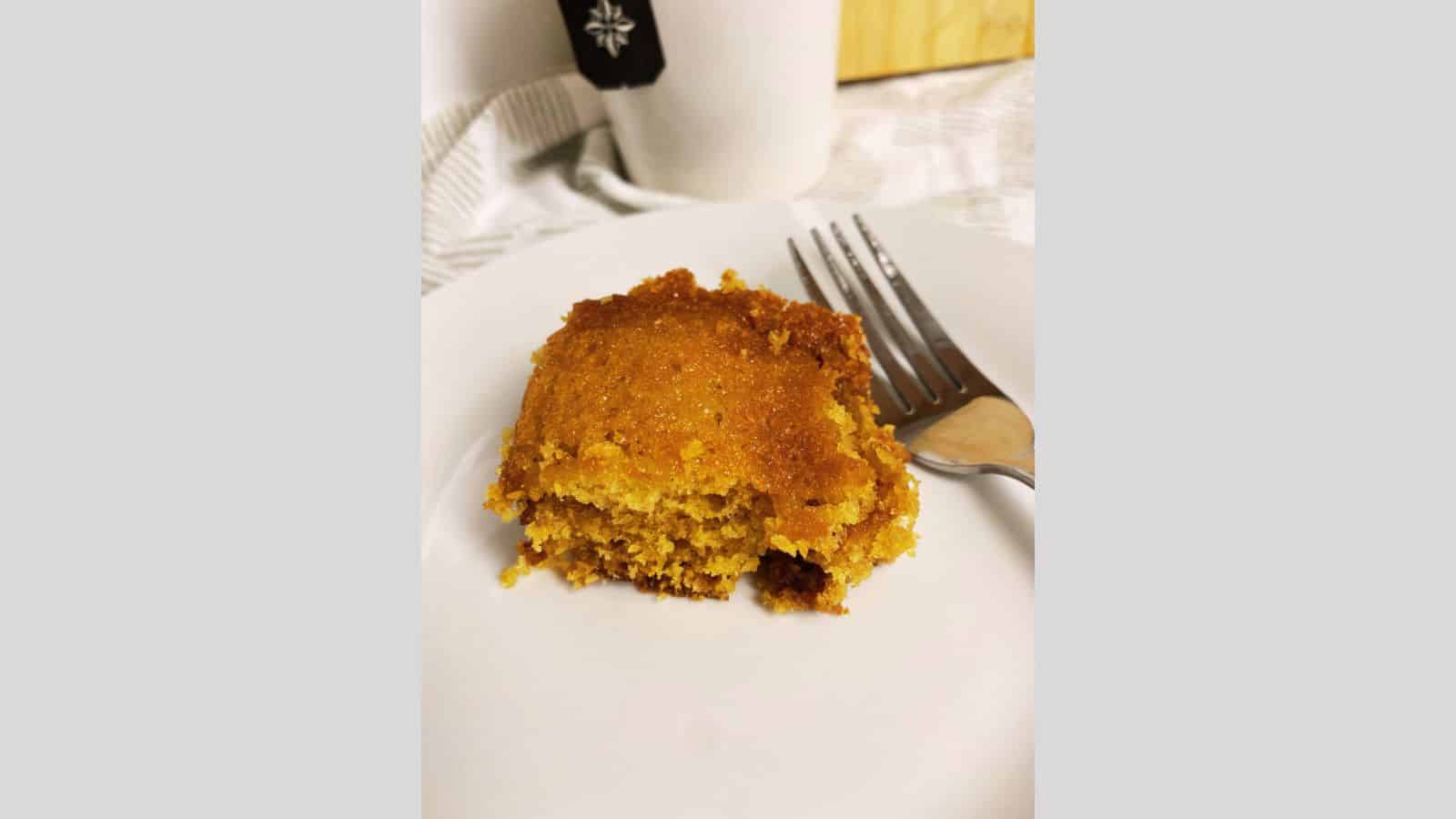 Slice of cinnamon crumb cake on white plate.