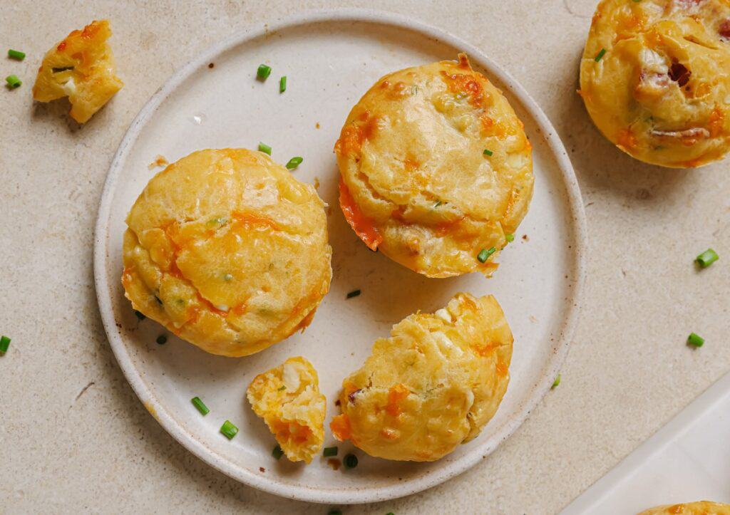Cottage cheese breakfast muffins on a plate with green onions.