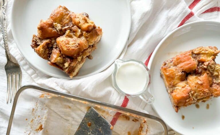 A slice of bread pudding on a plate with a fork.