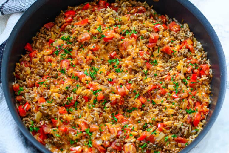 A skillet filled with rice and vegetables.