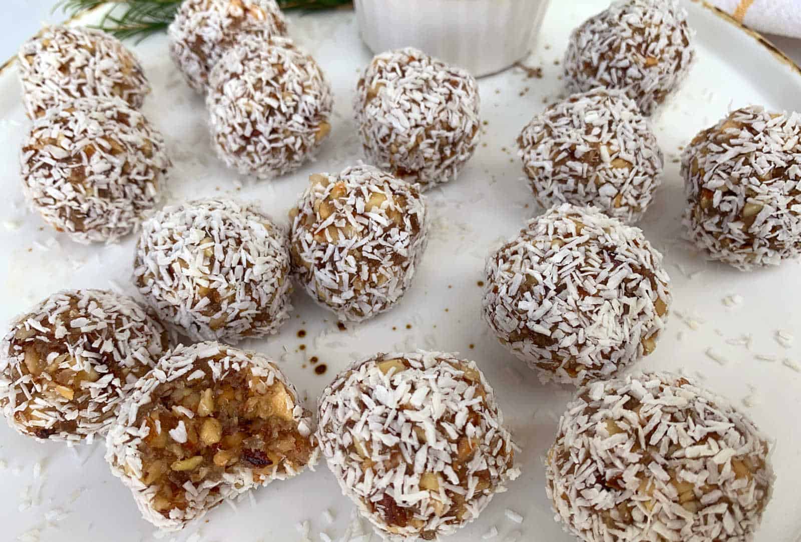Coconut energy balls on a white plate.