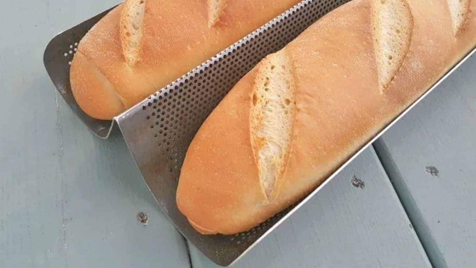 Image shows a closeup of two Baguettes in their pan from an overhead view.