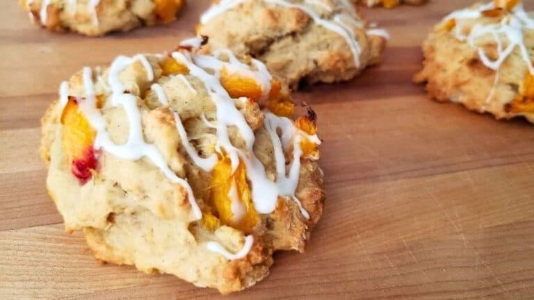 Image shows Peach scones with icing on a cutting board.