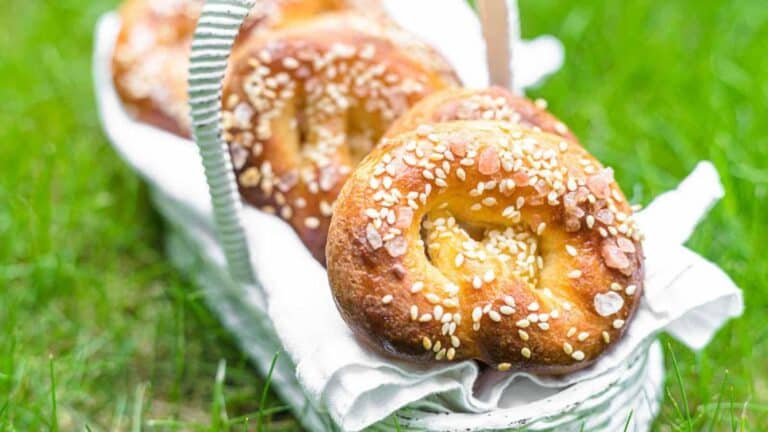 Pretzels in a basket on the grass.