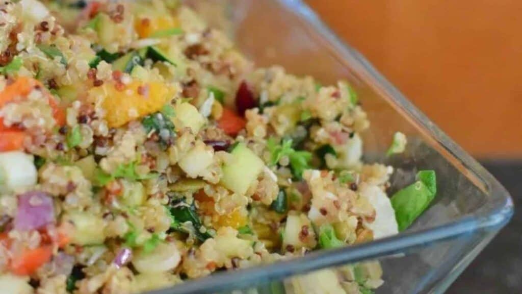 Quinoa salad in a clear glass bowl.