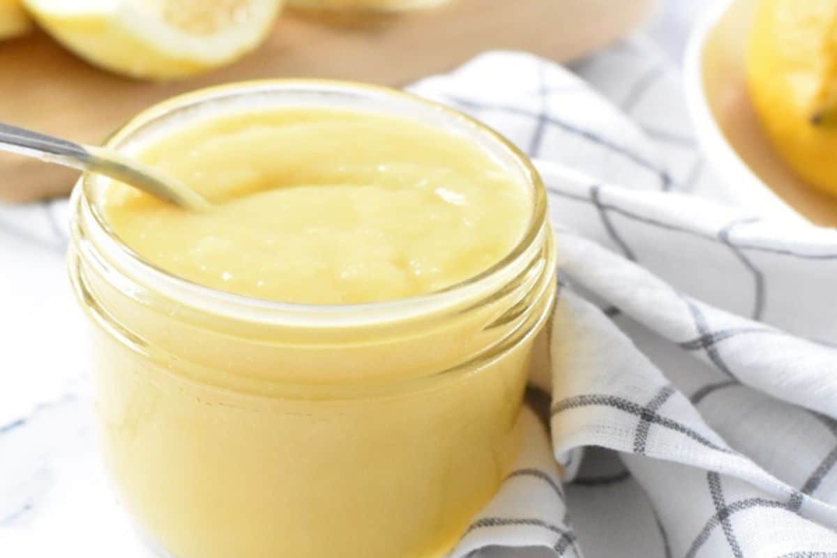 Two jars of lemon juice on a table.