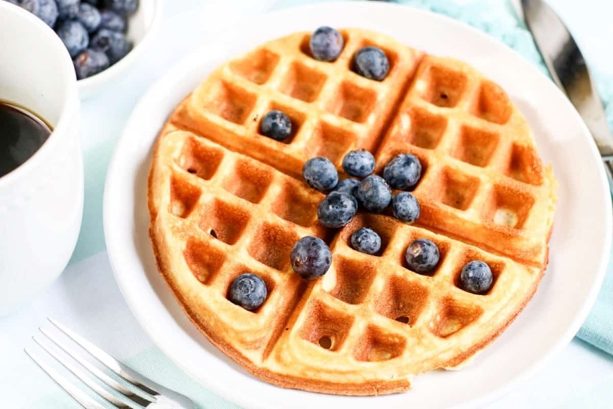 Waffles with blueberries and a cup of coffee.