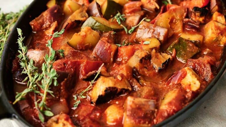 A skillet filled with vegetables and herbs.