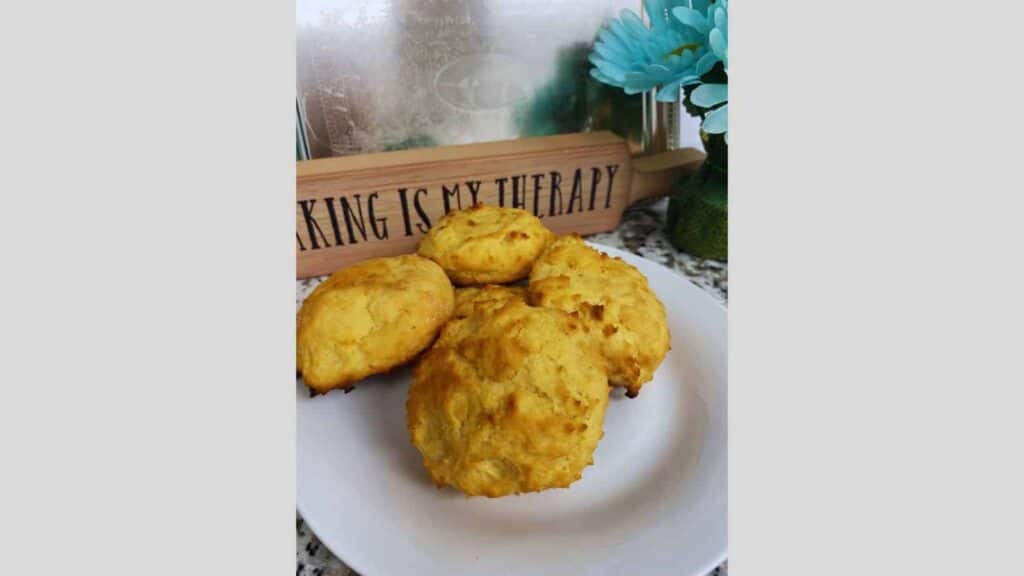 A plate of banana muffins on a table with a sign.