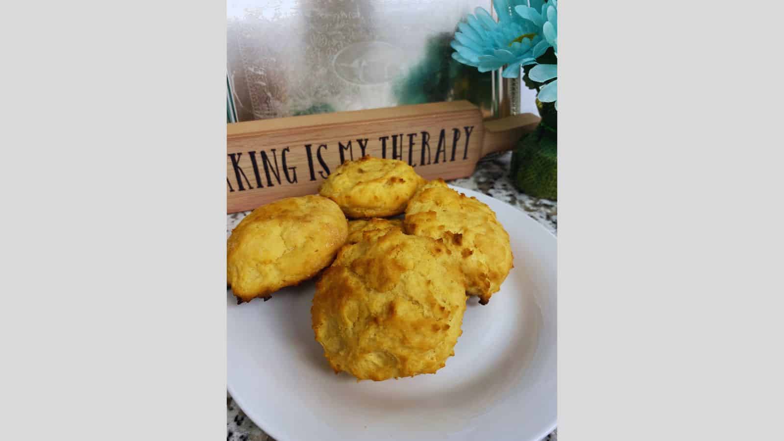 A plate of biscuits on a white plate with a sign.