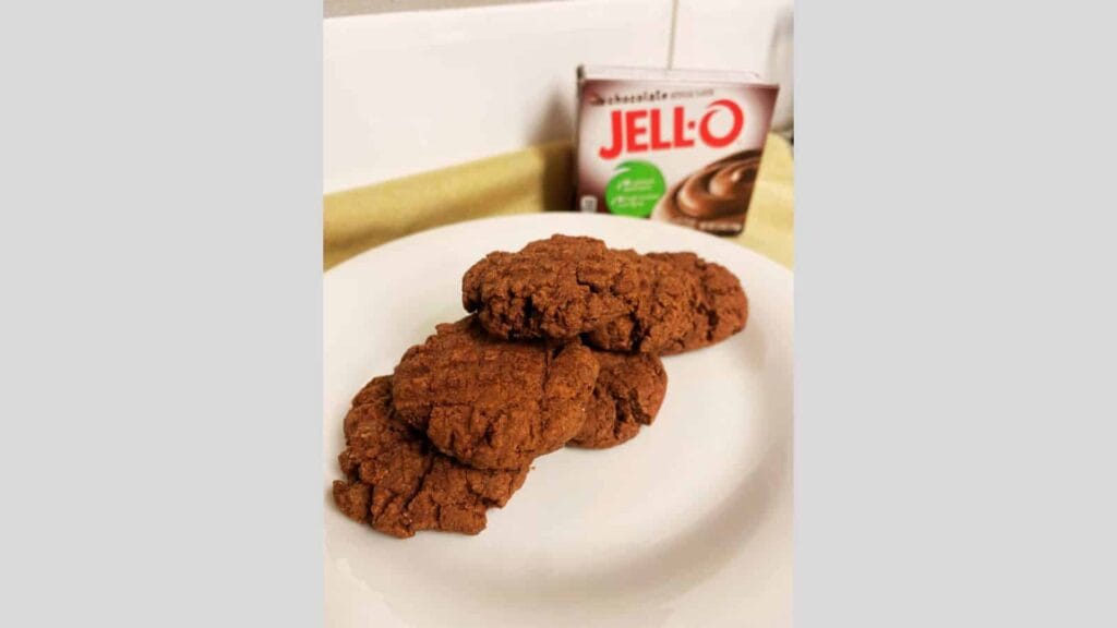 Chocolate cookies on a plate next to a box of oleo.