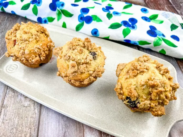 Rhubarb blueberry muffins on a white plate.