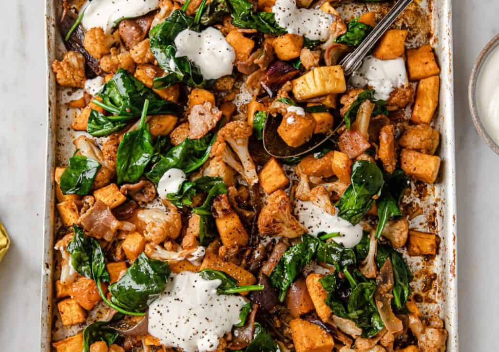Roasted sweet potatoes and spinach with sour cream.