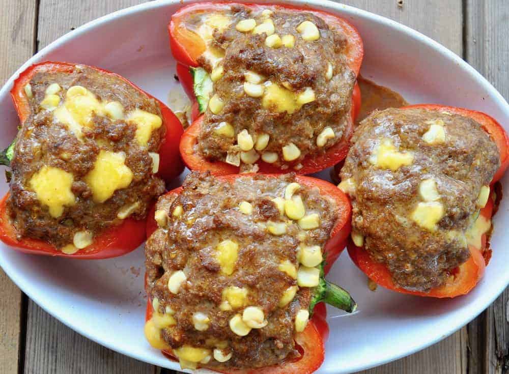 Stuffed peppers in a white dish.