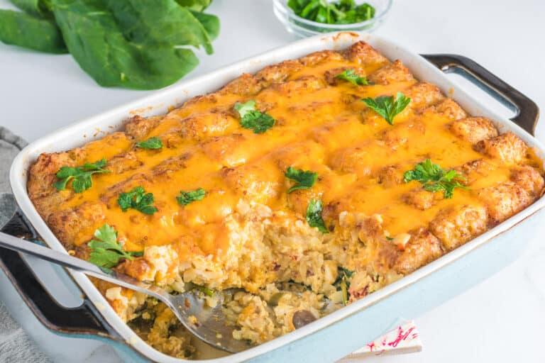 A casserole dish filled with cheese and spinach.