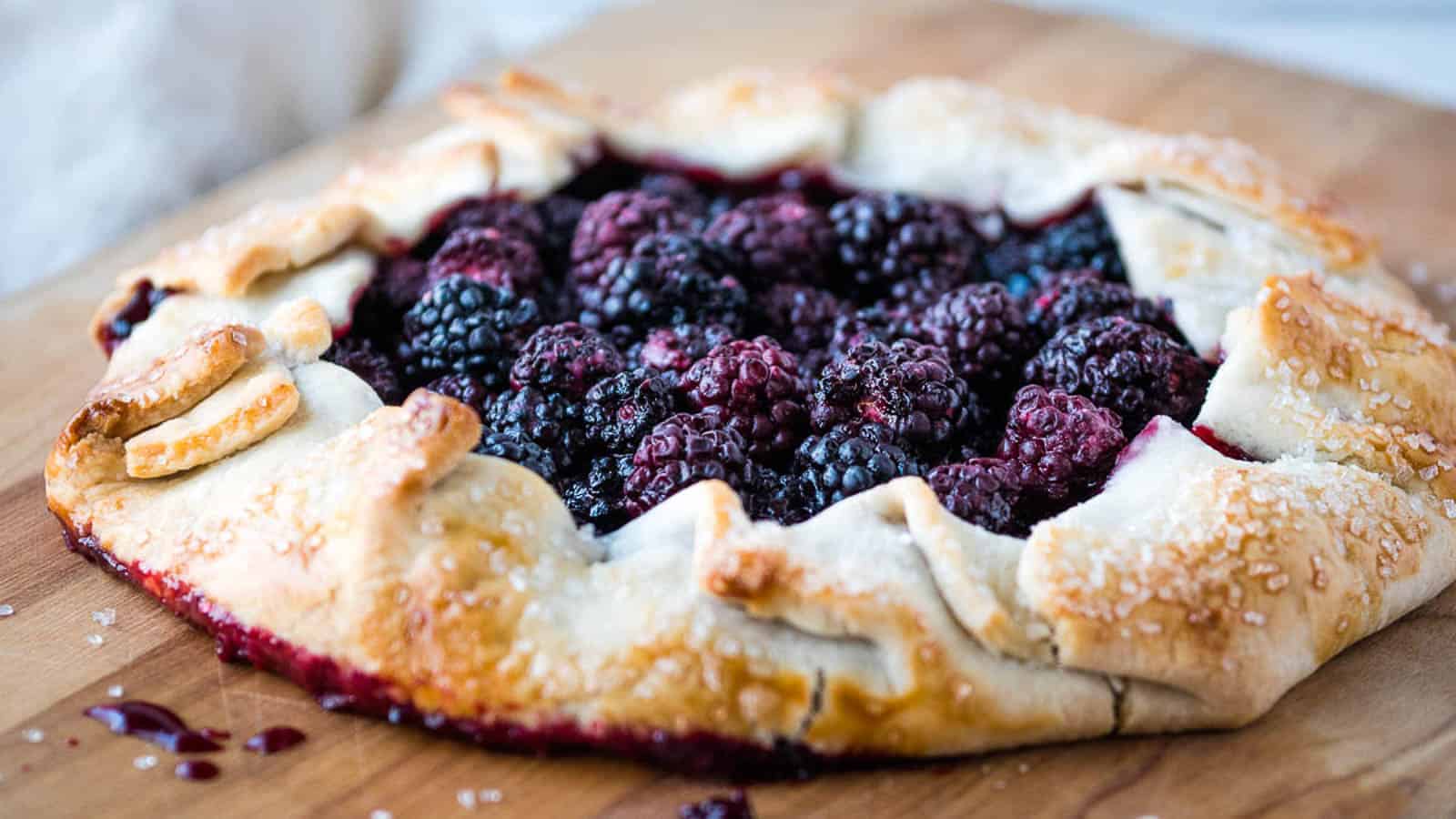 Blackberry galette topped with whipped cream.