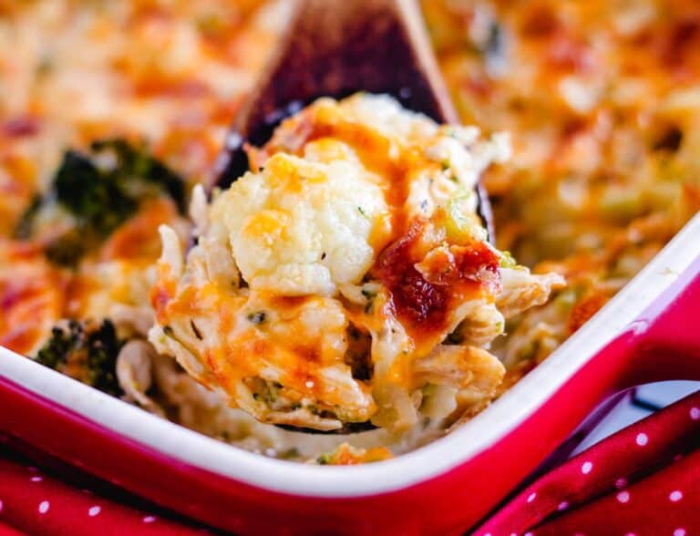 A casserole dish with chicken, broccoli and cheese.