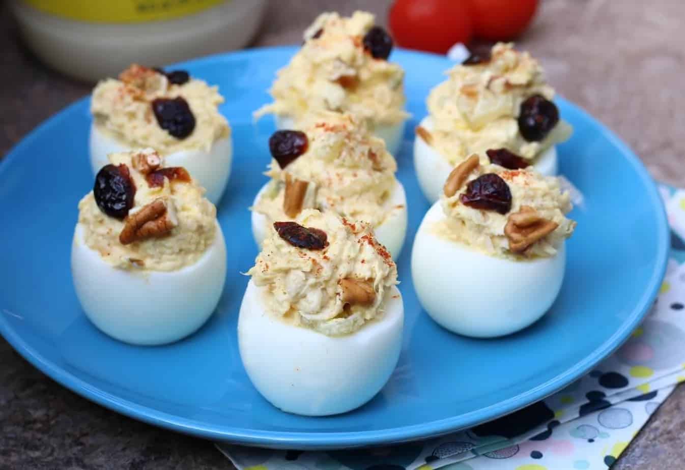 Blue plate with chicken salad deviled eggs.