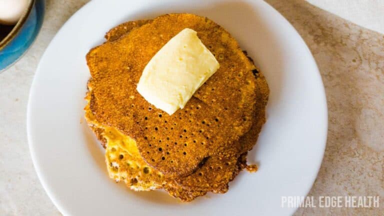 A plate of zero-carb pancakes with butter on it.