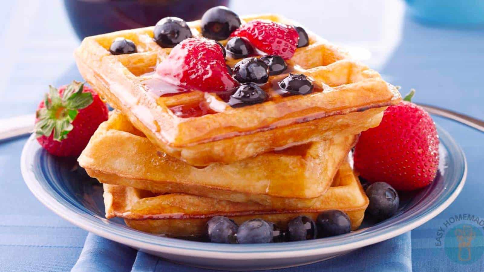 Easy waffle recipe with no milk stack on blue plate.