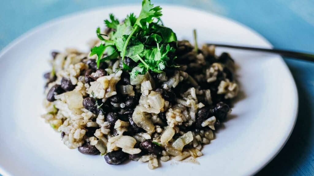 A plate with black beans and rice on it.